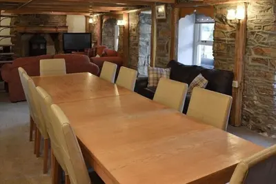 a dining room with a wooden table and chairs at Large Family House - sleeps 10. Central Location. 15 mins from coast. in Truro