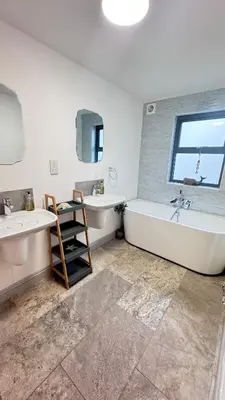 a bathroom with two sinks and a tub and a window at Tregenna House - St Ives, A Beautiful Newly Refurbished 4 Bedroom Family Town House With Alfresco Dining Garden and Private Parking Spaces in St Ives