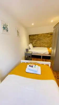 a small room with two beds in it at SPINDRIFT is A Beautiful Newly Refurbished THREE BEDROOM Private Family House located on the OLD HARBOUR and the COASTAL PATH in the Heart of Beautiful POLPERRO in Polperro