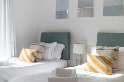 two beds sitting next to each other in a room at Trewhiddle 40 - A Luxury Cottage by Together Travel in St Austell