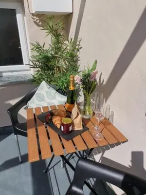 a small table with a bottle of wine and bread at Seashells at 2 TRENCROM COURT ST IVES in Carbis Bay