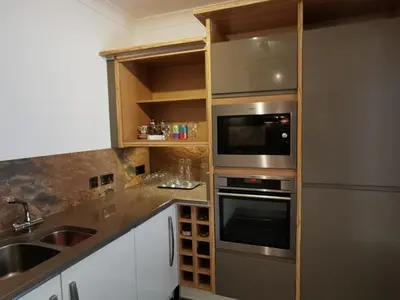 a kitchen with stainless steel appliances and a sink at Sandsifter at 4 Trencrom Court, Carbis Bay,St Ives, Cornwall in Carbis Bay