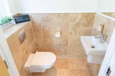 a bathroom with a toilet and a sink at Trewhiddle Retreat V8 by Together Travel - Luxury 3-Bedroom Villa in St Austell