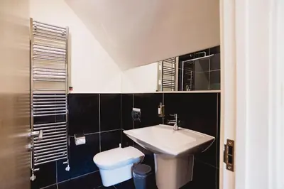 a bathroom with a sink and a toilet at Trewhiddle Retreat V31 by Together Travel - Luxury 3-Bedroom Villa in St Austell
