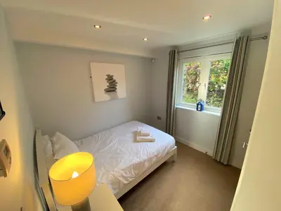 a small room with a bed and a window at Trewhiddle Retreat V29 by Together Travel - Luxury 4-Bedroom Villa in St Austell