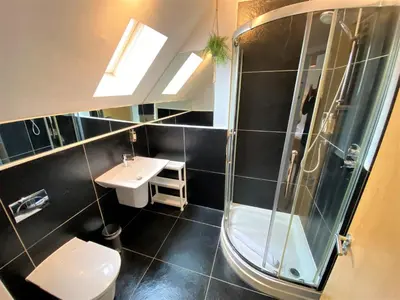 a bathroom with a shower and a toilet and a sink at Trewhiddle Retreat V29 by Together Travel - Luxury 4-Bedroom Villa in St Austell