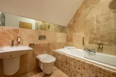 a bathroom with a sink and a toilet and a tub at Trewhiddle Retreat V27 by Together Travel - Luxury 3-Bedroom Villa in St Austell