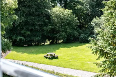 a park with a picnic table in the grass at Trewhiddle Retreat V27 by Together Travel - Luxury 3-Bedroom Villa in St Austell