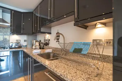 a kitchen with a sink and a counter top at Trewhiddle Retreat V25 by Together Travel - Luxury 4-Bedroom Villa in St Austell