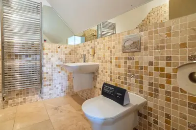 a bathroom with a toilet and a sink at Trewhiddle Retreat V25 by Together Travel - Luxury 4-Bedroom Villa in St Austell