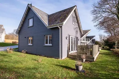a black and white house with a yard at Trewhiddle Retreat V24 by Together Travel - Luxury 4-Bedroom Villa in St Austell