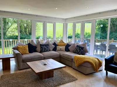 a living room with a couch and a coffee table at Trewhiddle Retreat V23 by Together Travel - Luxury 4-Bedroom Villa in St Austell