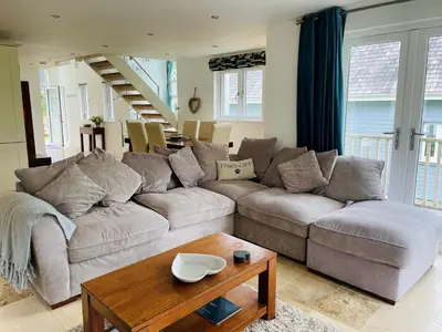 a living room with a couch and a table at Trewhiddle Retreat V20 by Together Travel - Luxury 3-Bedroom Villa in St Austell