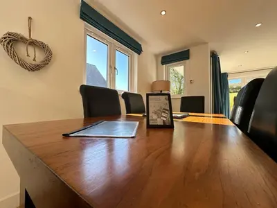 a conference room with a wooden table and chairs at Trewhiddle Retreat V20 by Together Travel - Luxury 3-Bedroom Villa in St Austell
