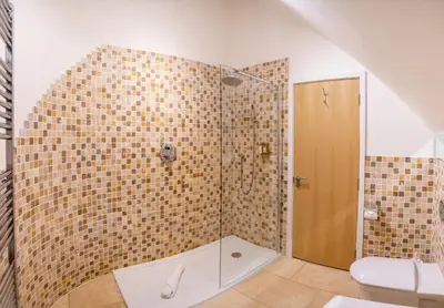 a bathroom with a shower with a toilet at Trewhiddle Retreat V17 by Together Travel - Luxury 4-Bedroom Villa in St Austell