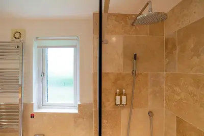 a bathroom with a shower and a window at Trewhiddle Retreat V17 by Together Travel - Luxury 4-Bedroom Villa in St Austell