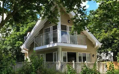 a house with a balcony on the side of it at Trewhiddle Retreat V19 by Together Travel - Luxury 4-Bedroom Villa in St Austell
