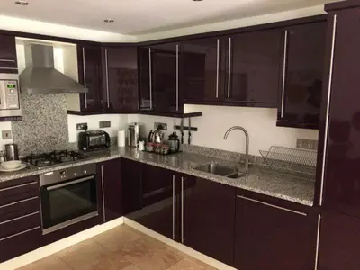 a kitchen with dark brown cabinets and a sink at Trewhiddle Retreat V19 by Together Travel - Luxury 4-Bedroom Villa in St Austell