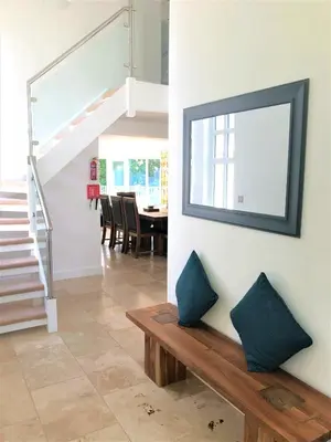 a living room with a bench and a mirror on the wall at Trewhiddle Retreat V19 by Together Travel - Luxury 4-Bedroom Villa in St Austell
