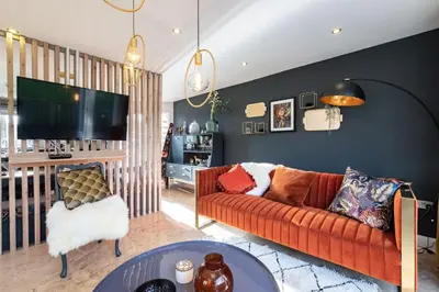 a living room with a couch and a tv at Trewhiddle Retreat V5 by Together Travel - Luxury 4-Bedroom Villa in St Austell