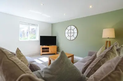 a living room with a couch and a tv at Trewhiddle 41 by Together Travel - Stylish Coastal Countryside Retreat in St Austell