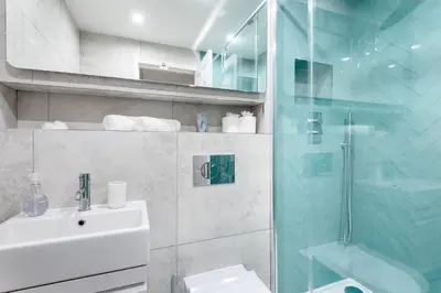 a bathroom with a sink and a glass shower at Hideaway - Exclusive marina development, town centre, with parking in Falmouth