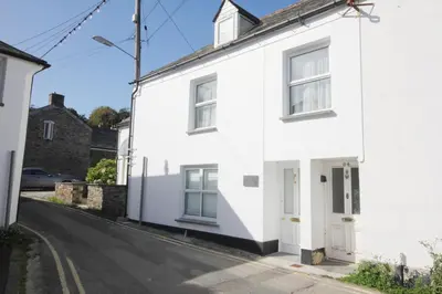 a white house on the side of a street at 36 High Street in Padstow