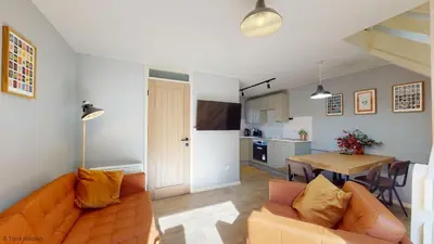 a living room with a couch and a table at 19 Strawberry Hill, Tolroy Manor in Hayle