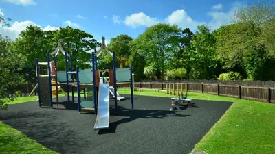 a playground with a slide in a park at 19 Strawberry Hill, Tolroy Manor in Hayle