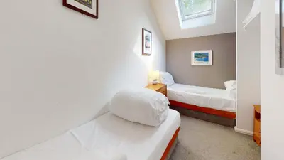 a small bedroom with two beds and a window at 24 Strawberry Hill, Tolroy Manor in Hayle