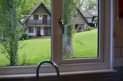 a window view of a yard from a house at 36 Strawberry Hill, Tolroy Manor in Hayle