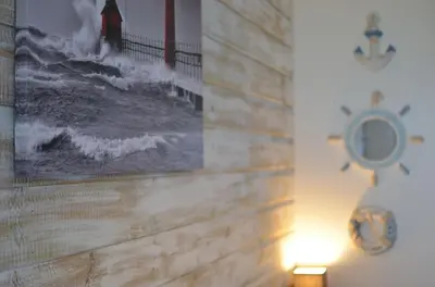 a picture on a wall with a clock on it at 36 Strawberry Hill, Tolroy Manor in Hayle