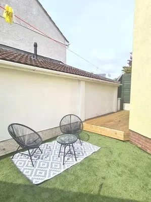 two chairs and a table on a patio at Cosy Self Contained Annexe in Bodmin
