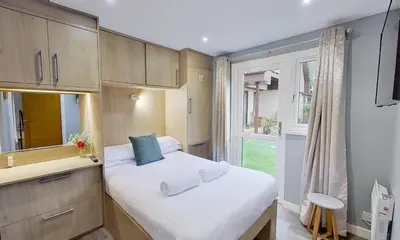 a small bedroom with a bed and a window at 23 Trevithick Court, Tolroy Manor in Hayle