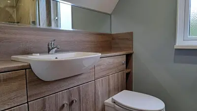 a bathroom with a white sink and a toilet at 23 Trevithick Court, Tolroy Manor in Hayle
