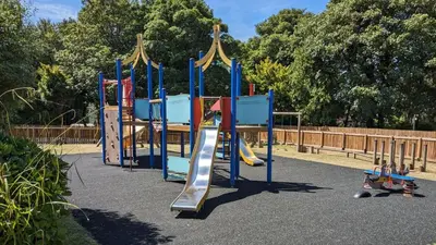 a row of playground equipment in a park at 23 Trevithick Court, Tolroy Manor in Hayle