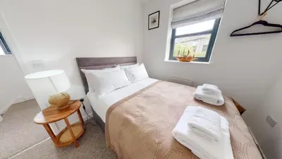 a small bedroom with a bed and a window at 05 Queensway Gardens, Hayle in Hayle