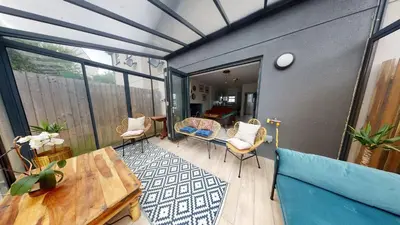 a screened in porch with a table and chairs at 05 Queensway Gardens, Hayle in Hayle