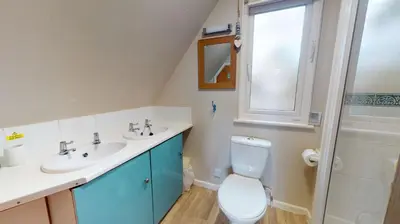 a bathroom with a toilet and a sink and a shower at 34 Trevithick Court, Tolroy Manor in Hayle