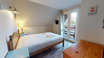 a small bedroom with a bed and a window at 34 Trevithick Court, Tolroy Manor in Hayle