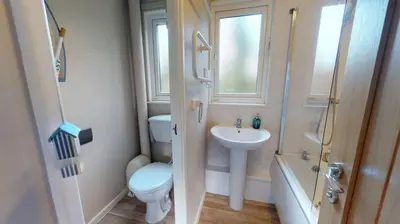 a small bathroom with a toilet and a sink at 34 Trevithick Court, Tolroy Manor in Hayle