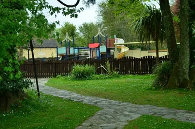a park with a playground behind a fence at 37 Trevithick Court, Tolroy Manor in Hayle