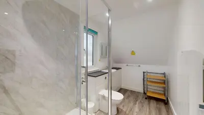 a bathroom with a toilet and a glass shower at 37 Trevithick Court, Tolroy Manor in Hayle