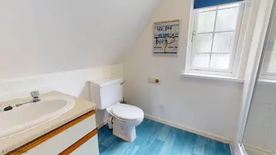 a bathroom with a white toilet and a sink at 15 Tudor Court, Tolroy Manor in Hayle