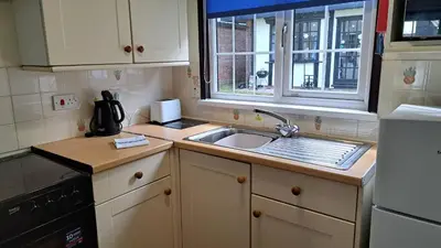 a small kitchen with a sink and a window at 15 Tudor Court, Tolroy Manor in Hayle