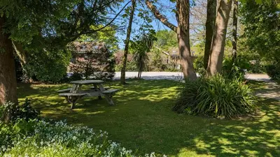 a picnic table in a park with trees and grass at 01 Tudor Court, Tolroy Manor in Hayle