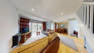 a living room with a couch and a tv at 25 Tudor Court, Tolroy Manor in Hayle