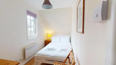 a small room with a bed and a window at 25 Tudor Court, Tolroy Manor in Hayle