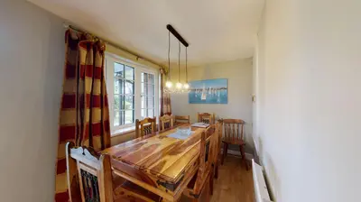 a dining room with a wooden table and chairs at 25 Tudor Court, Tolroy Manor in Hayle