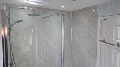 a shower with a glass door in a bathroom at 28 Tudor Court, Tolroy Manor in Hayle
